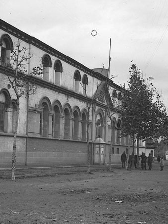Vista de la façana de la caserna d'Artilleria General Mendoza, situada al passeig homònim. Al fons, el convent de Sant Francesc de Paula, conegut popularment com els Mínims. 1930-1940